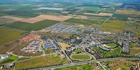An aerial view of the entire Two Wells township, taken on a sunny day in 2022.